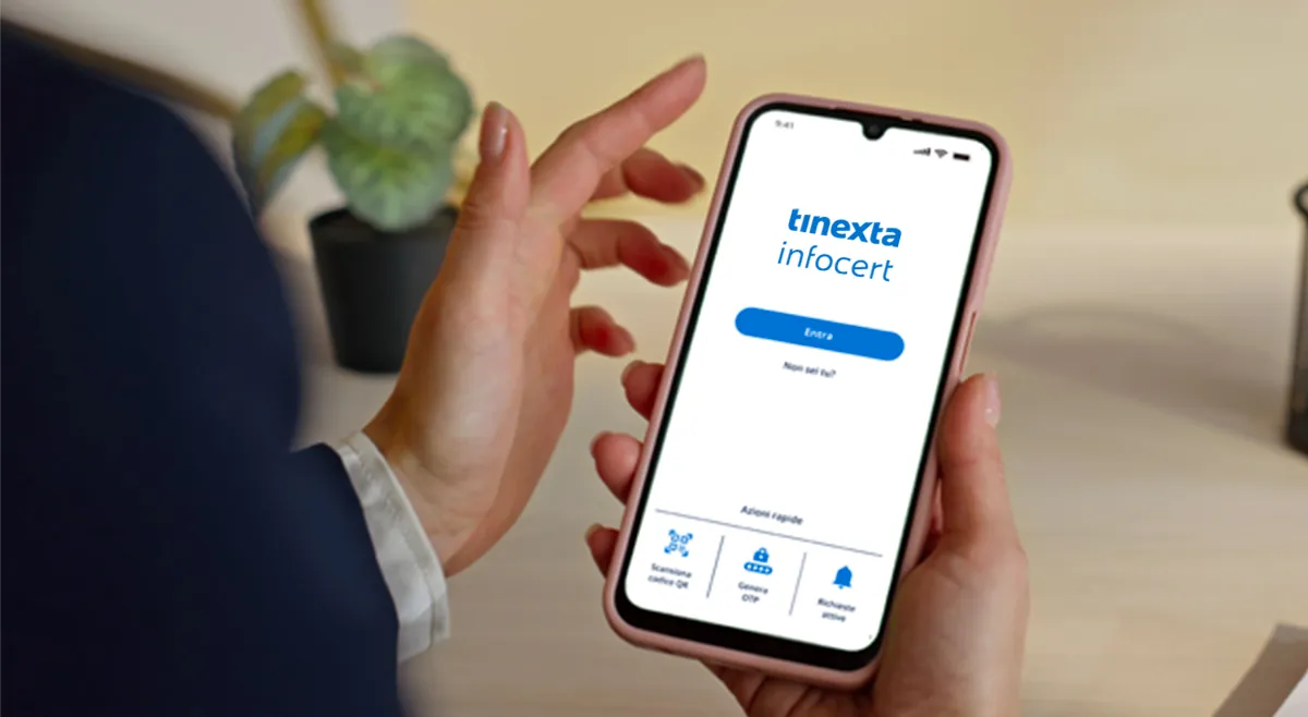 Persona tiene in mano uno smartphone con schermata dell’app Tinexta Infocert